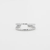 Silver ring on a light gray background, close up front view